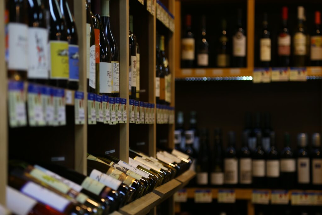 Image of wine bottles presented on a shelves of wine shop