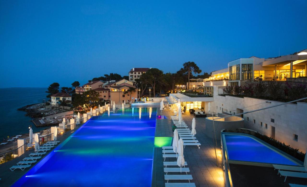 Image shows a outdoor pool at night at Vitality Hotel Punta