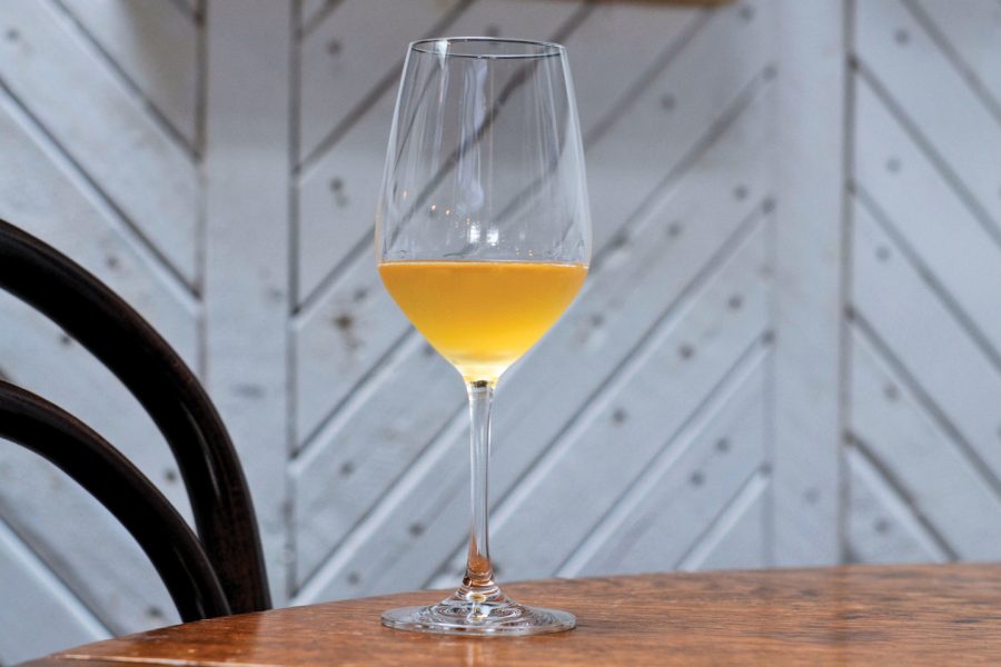 Image of a glass of natural wine on a wooden table