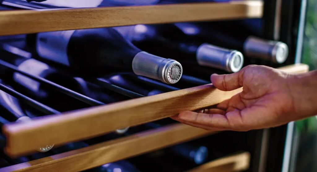 Image of wine fridge shelves with bottles of wine