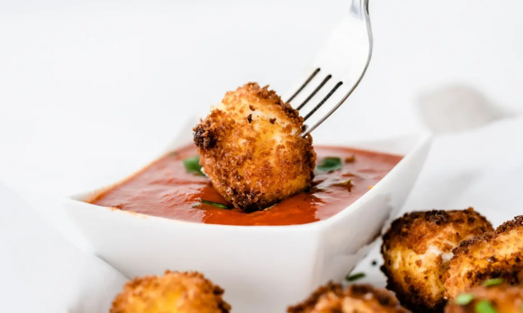 Fried goat cheese served with a red sauce