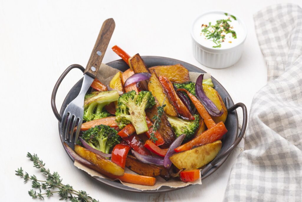 Grilled vegetables served on a plate with a fork